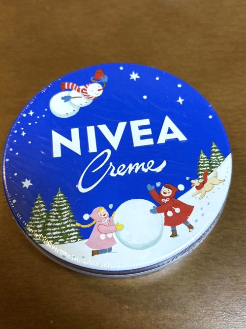 Nivea cream can with a limited winter design (illustration of a snowman and children)