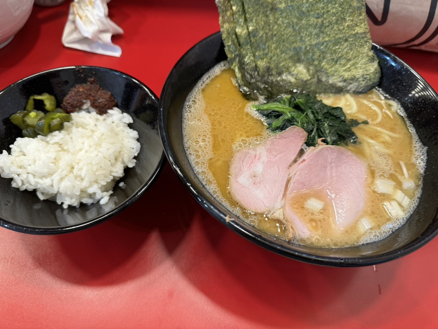 Taniseya ramen and rice set with spicy condiments, pickles, and rich pork-bone broth — perfect satisfaction meal.