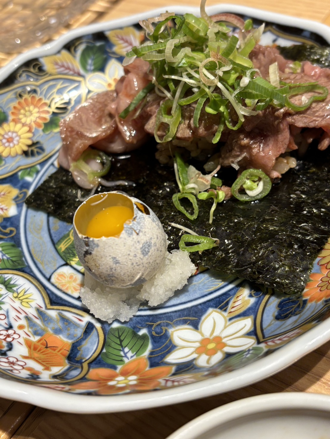 Sukiyaki-style wagyu beef sushi served with quail egg at Ninoya Hamamatsucho Tokyo.
