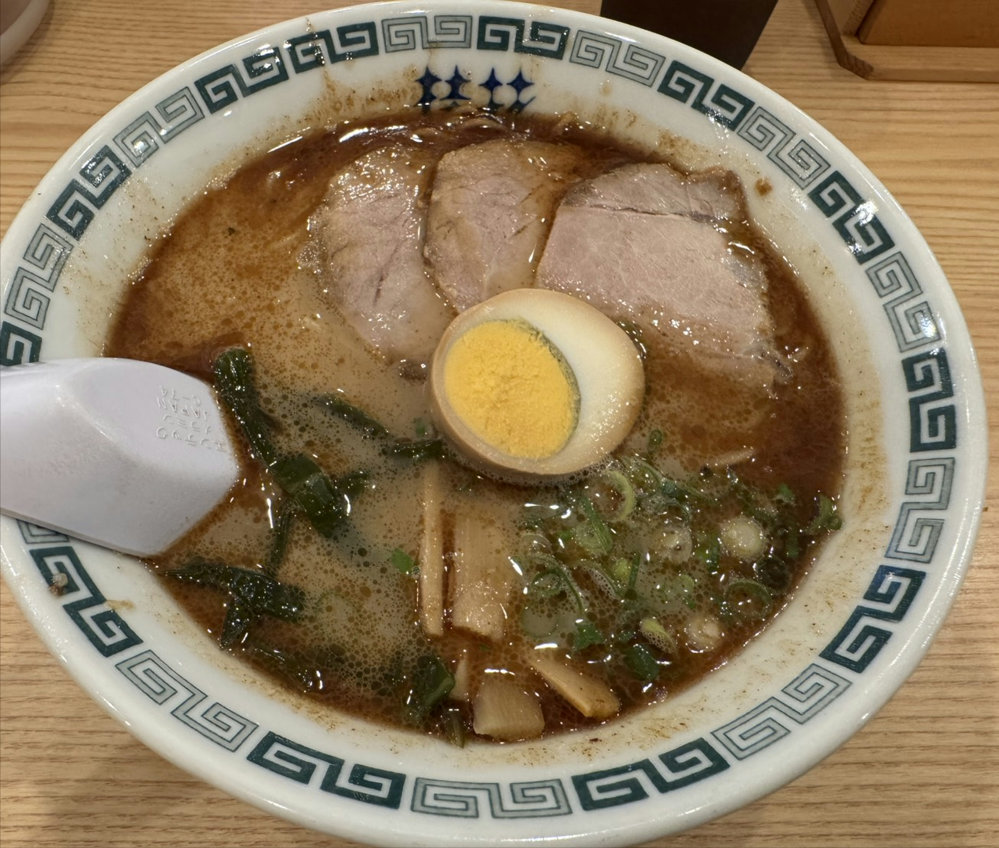 A bowl of Keika Thin Noodle Ramen (細麺桂花) with chashu pork, seasoned egg, bamboo shoots, and green onions at Keika Ramen in Tokyo, Japan.