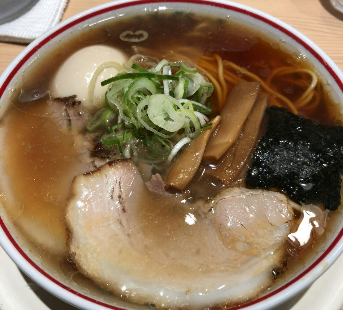 A bowl of light niboshi shoyu ramen served at Tokyo Niboshi Ramen Gyoku in Tokyo Station Ramen Street.