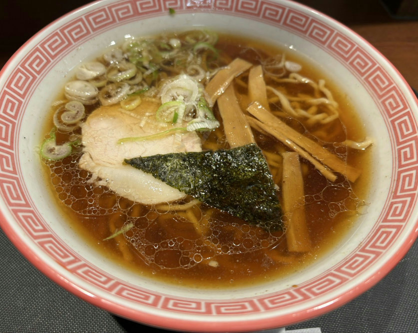 A bowl of classic shoyu ramen with niboshi flavor and curly noodles served at Harukiya in Lazona Kawasaki Plaza.