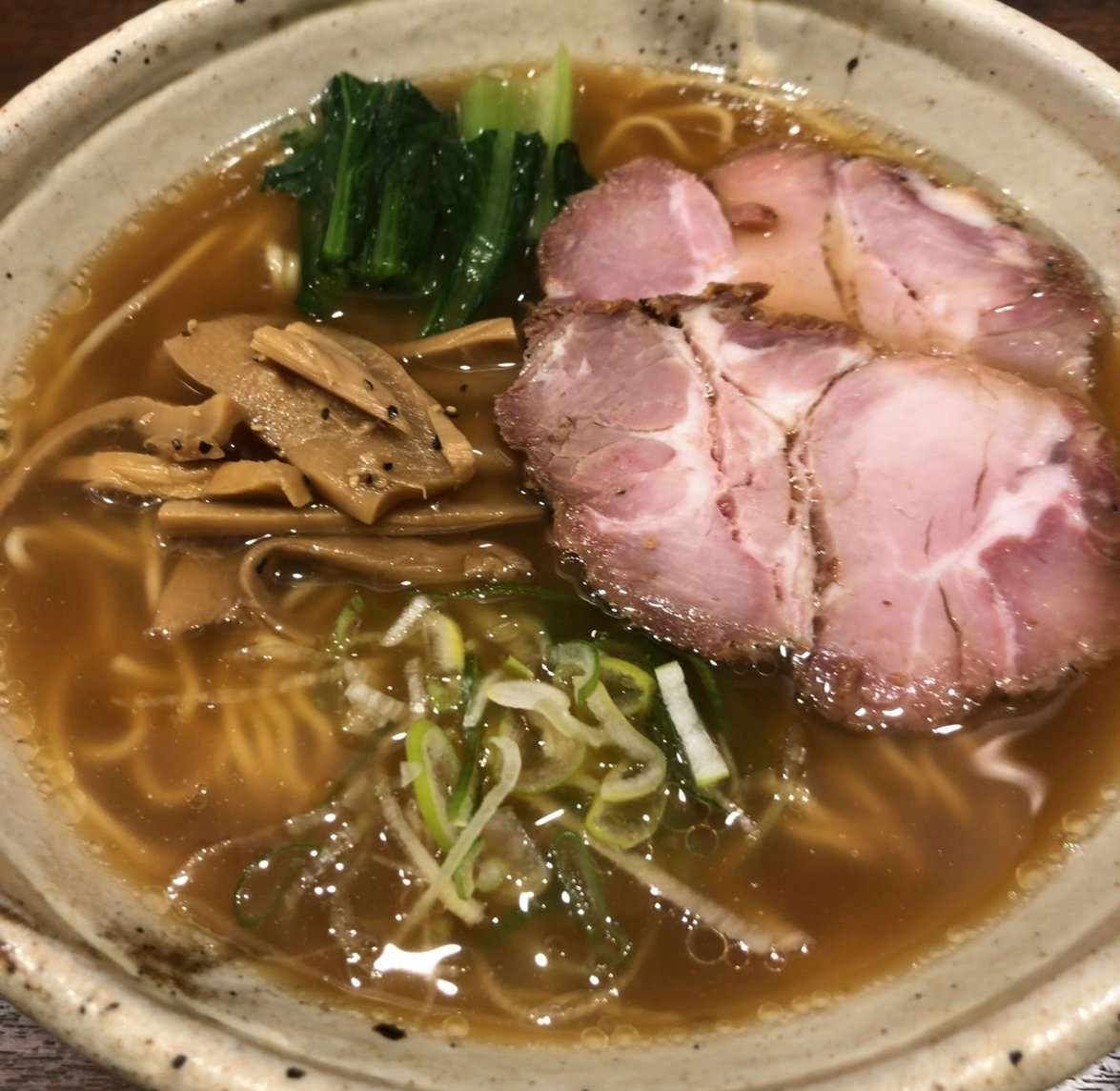 A bowl of shoyu ramen served at Ramen Ichiro in Ginza, Tokyo, featuring Aomori Shamorock chicken and grilled dried fish broth.