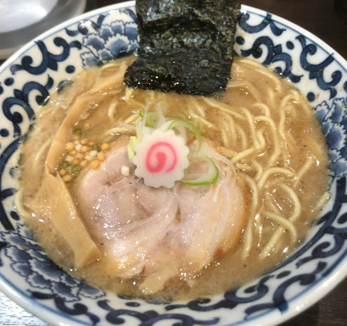 A bowl of gyokai tonkotsu ramen served at Ikaruga in Tokyo Station Ramen Street, featuring a rich seafood and pork broth.
