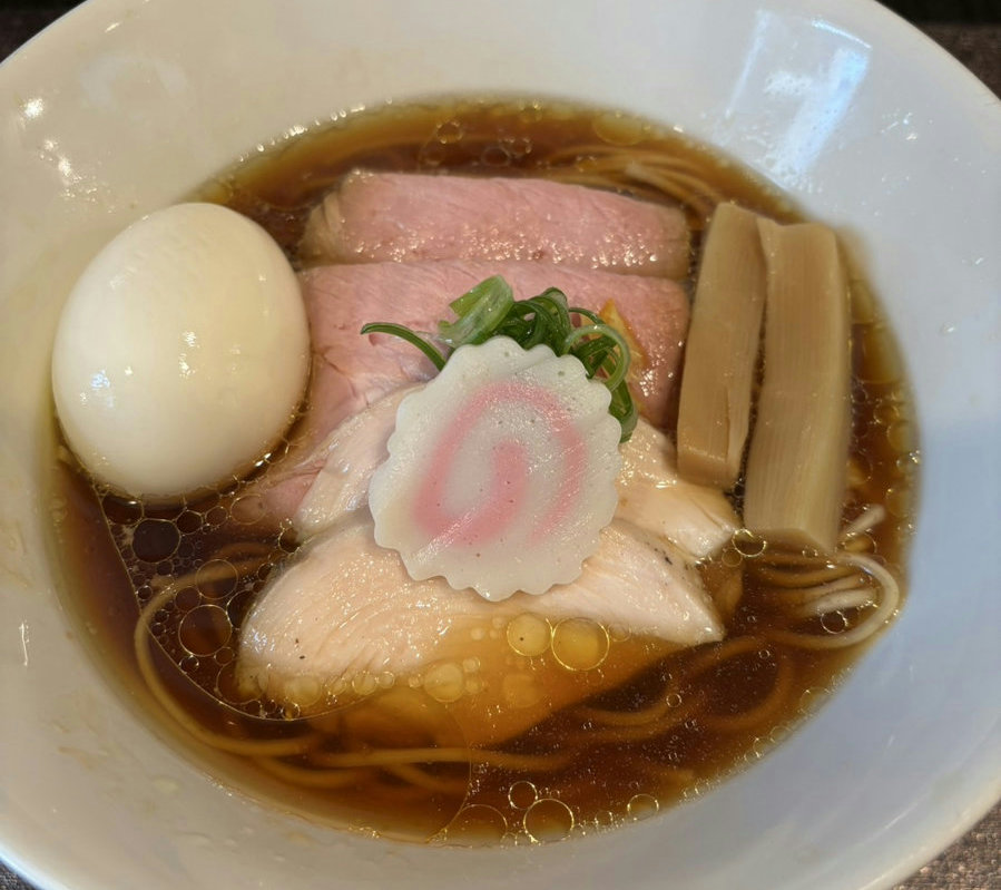 A bowl of ajitama shoyu ramen with a seasoned soft-boiled egg served at Korindo in Shimbashi, Tokyo.