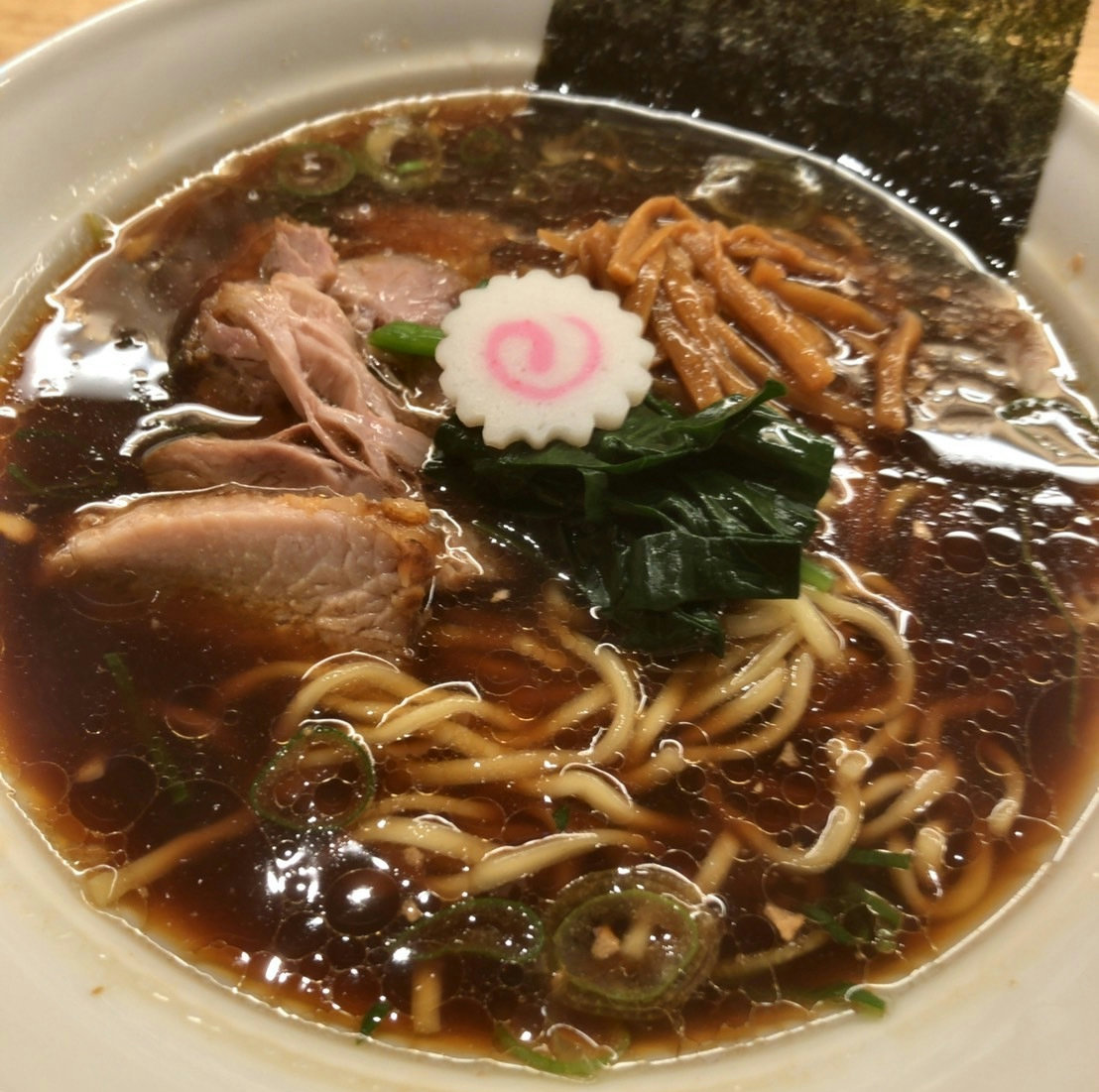 A bowl of Nagaoka-style ginger shoyu ramen served at Nagaoka Shokudo in Tokyo Ramen Yokocho near Tokyo Station.