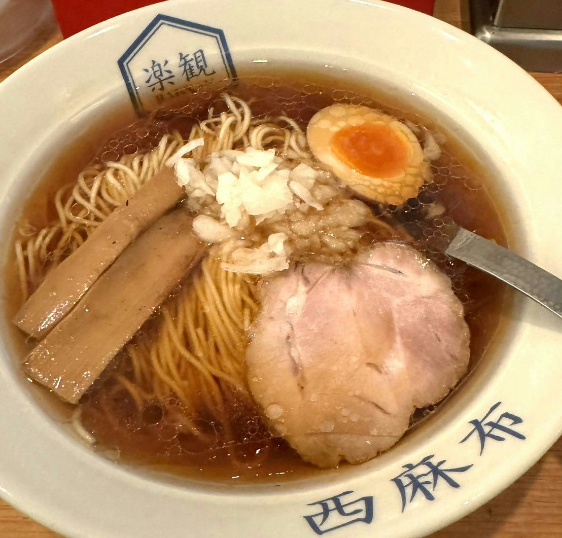 A bowl of Kohaku shoyu ramen served at Rakkan in Nishiazabu, Tokyo, featuring a clear soy sauce broth with bonito, kombu, and niboshi.